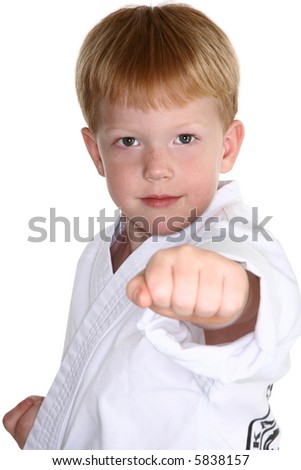 Boy making karate punch towards camera.  clipping path included.