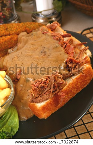 Open beef sandwich with gravy, macaroni and fried pickles.