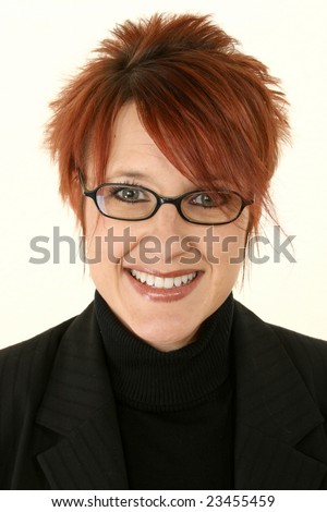 Smiling young woman with bright red hair wearing black rimmed eye glasses.