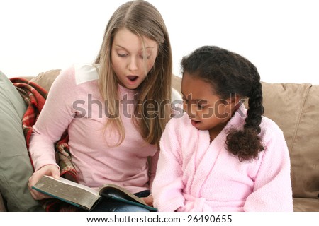 Adorable five year old African American Girl with babysitter reading.