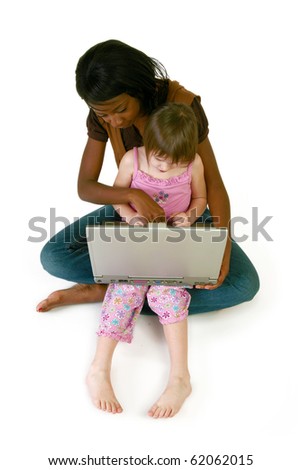 Attractive 20 year old African American woman helping 5 year old girl with laptop over white.
