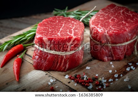 Raw beef filet Mignon steak on a wooden Board with pepper and salt, black Angus marbled meat Сток-фото © 