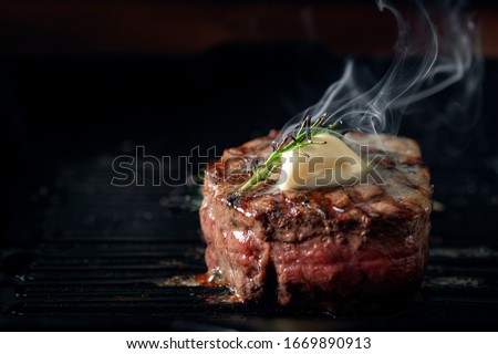 A steaming beef tenderloin steak is grilled in a grill pan with the text copy space. The concept of the recipe , filet Mignon Сток-фото © 