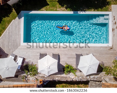 two person swim in the pool at the hotel. View from above, couple men and women in swimming pool of luxury vacation home in the Ardeche France Europe