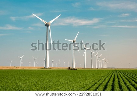 Similar – Image, Stock Photo A wind energy electric windmill turbine in a colorful sunset and landscape