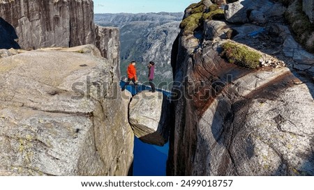 Similar – Image, Stock Photo Distant traveler on rocky formation in sea