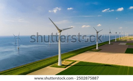 Image, Stock Photo View of a wind farm in a mountainous forest field with mountains in the background. View during the rising sun. Sunrise