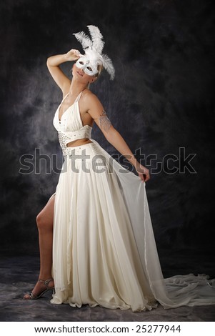 beautiful woman in wedding dress holding mask