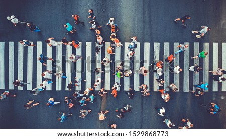 Aerial. People crowd motion through the pedestrian crosswalk. Top view from drone. Toned image. 商業照片 © 