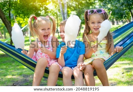 Similar – Image, Stock Photo Cheerful girl eating cotton candy on street