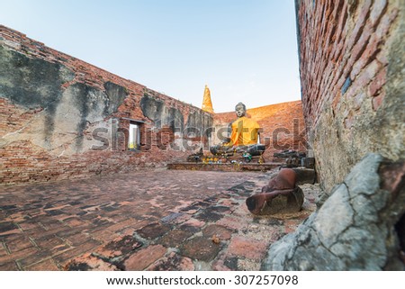 Asian religious architecture. Ancient sandstone sculpture of Buddha at Wat Phra Sri Sanphet temple ruins . Ayutthaya, Thailand travel landscape and destinations