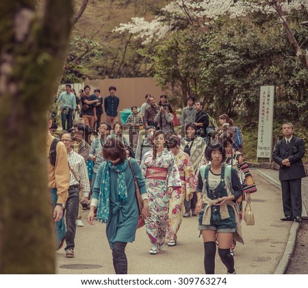 KYOTO, JAPAN - APRIL 4 2015: Tourists walk on a street leading to Kiyomizu Temple on April 4 2015 for Sakura viewing. Kiyomizu is a famous temple in Kyoto built in year 778