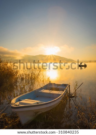 Boats on the lake Kawaguchiko, sunrise,,People fishing on a boat,silhouette