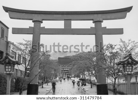 KYOTO, JAPAN- APRIL 5, 2015: Many unidentified tourists visit Fushimi Inari Shrine ,black and white