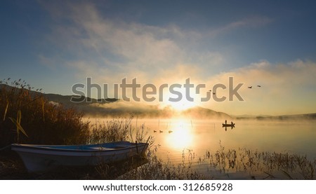 Sunrise at the lake Kawaguchiko,People fishing on a boat,silhouette