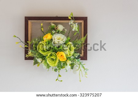 Fake flowers with white wall