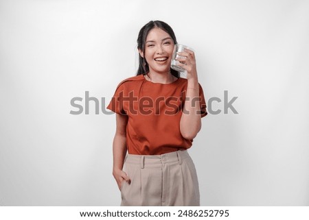 Similar – Image, Stock Photo Stylish young asian woman dressed in casual wear looking to mobile phone screen when posting photos in social media and thinking about interesting content text. Lifestyle blogger checking blog comments outdoor at autumn