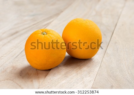 Orange fruits on the wooden floor.