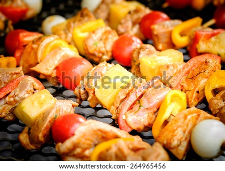 Bar-B-Q or BBQ with kebab cooking. Coal grill of pork skewers with tomatoes, onion and peppers. barbecue camping dinner.