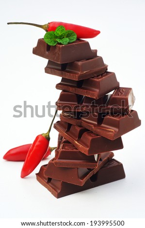 dark chocolate and red chilly on white background