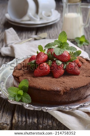 Chocolate truffle cake with fresh strawberries on a top