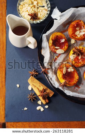 baked peaches with a cinnamon, anise, maple syrup and almond flakes. selective focus