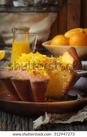 Citrus Syrup Cake on a Bamboo Platter and Wooden Rustic Background. Selective Focus