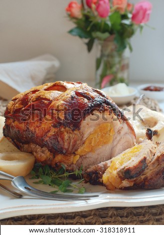 Slow-roasted pork shoulder with apricot and thyme stuffing. Selective focus