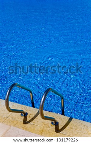 Swimming pool with chrome grab bars