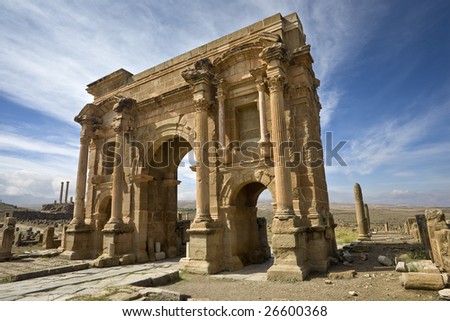 Algeria. Timgad (ancient Thamugadi or Thamugas). Triumphal arch, called Trajan\'s Arch and fragment of Decumanus Maximus street