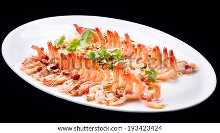 Shrimp prawn appetizer cooked seasoned seafood dish  isolated on black background , chinese cuisine