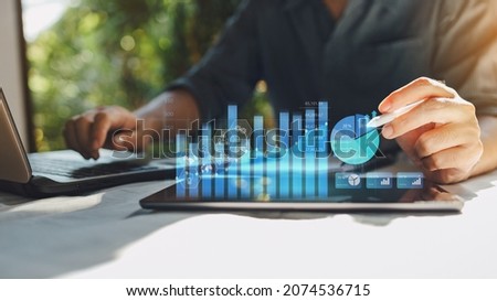 Businessman work with ai for economy analysis financial result by digital augmented reality graph. Concept for entrepreneur leader of invest in business and digital marketing technology of the future. Foto stock © 
