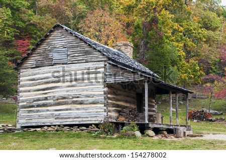 Old Log Cabin in the wooded forest in the fall season