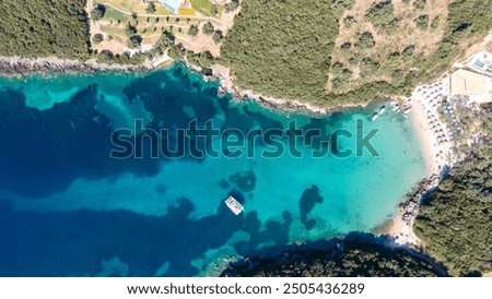 Similar – Foto Bild Segelyacht vor Anker in einer Bucht, durch Blätter einer Agave im Vordergrund gesehen, die ein Muster bilden