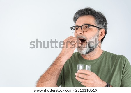 Similar – Image, Stock Photo Senior man taking prescription medicine at home