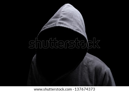 Menacing silhouette of hooded man in the shadow
