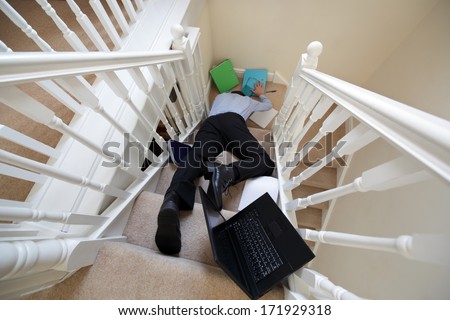 Business man falling down the stairs in the office concept for accident and insurance injury claim at work