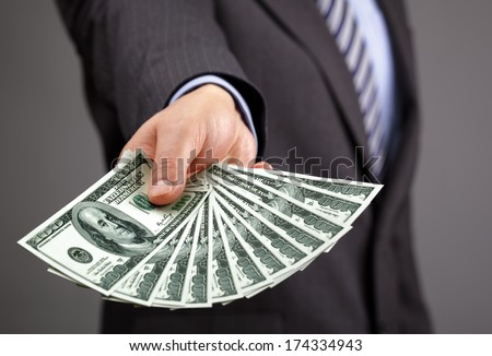 Businessman holding one hundred dollar bills concept for paying, business wealth and banking