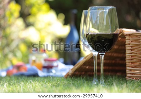 Wine glasses and hamper picnic scene