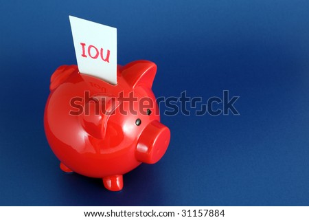 IOU card in piggy bank signifying debt or financial problems