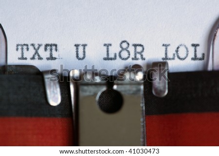 Message using popular texting abbreviation on an old fashioned typewriter - text messaging concept
