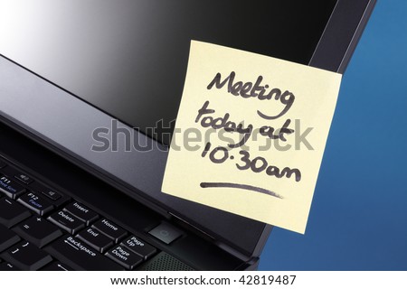 Yellow sticky note on a laptop computer reminding of a meeting today