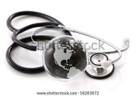 Stethoscope next to glass globe world map concept for global medical solutions