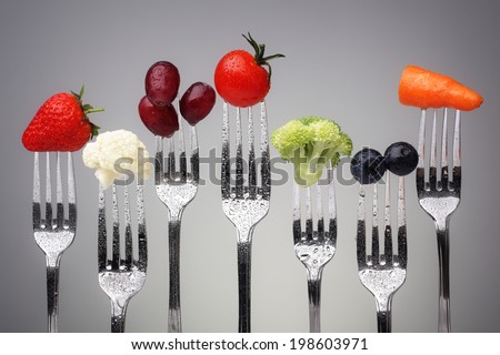 Fruit and vegetable of silver forks against a grey background concept for healthy eating, dieting and antioxidant 商業照片 © 