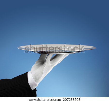 Waiter holding an empty silver platter ready for product placement ストックフォト © 