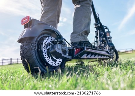 Similar – Image, Stock Photo Man riding an e-scooter