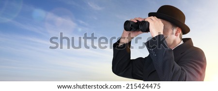 Businessman wearing bowler hat looking through binoculars concept for finance, future investment and searching