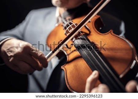 Similar – Foto Bild Nahaufnahme einer Violine mit Bogen. Braune Orchestergeige. Finger auf der Tastatur der Violine.