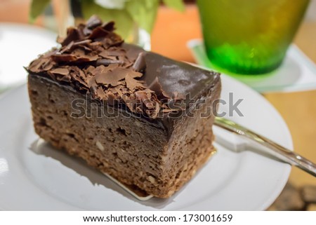 Dark chocolate cake with toppings for coffee break