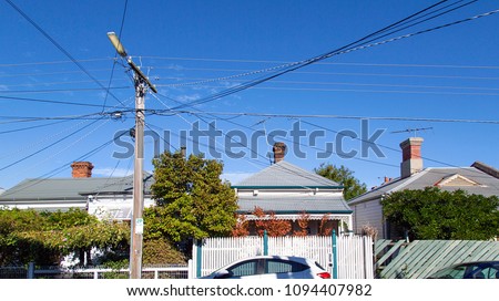 Similar – Image, Stock Photo Power poles in front of evening sky, taken through a power pole in the foreground, cropped, orange-black